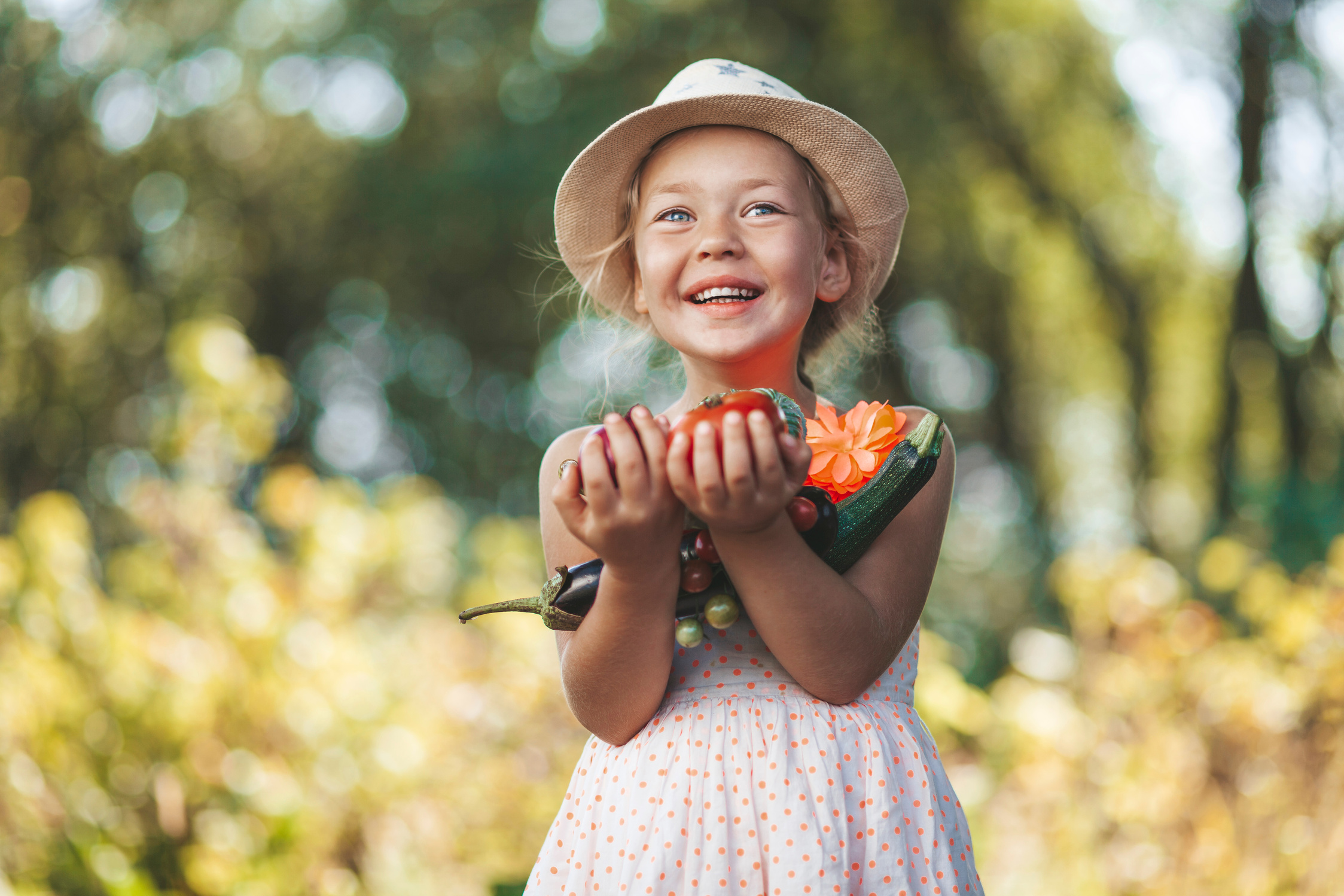 Happy girl holding homemade vegetables. Sustainable food gardening